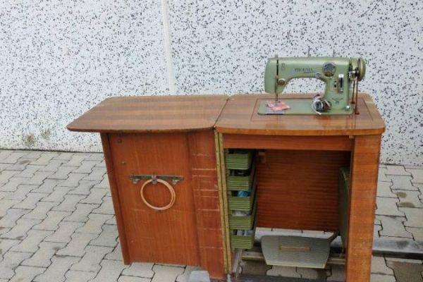 Alte Nähmaschine der Marke PHOEN mit Möbelstück