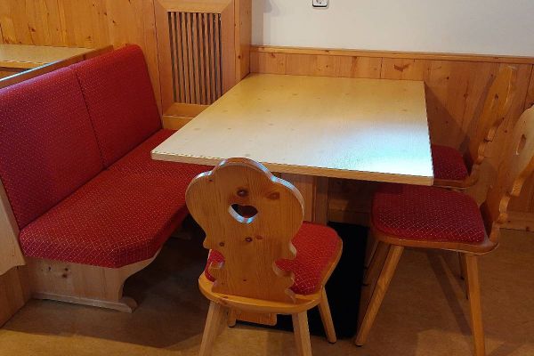 Tisch mit Stühlen, auch Küchenzeile mit Kochfeld und Kühlschrank
